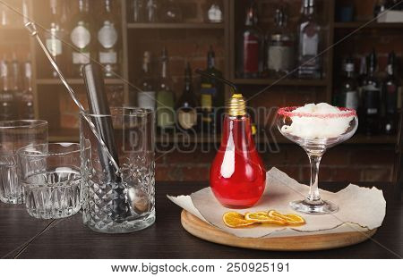 Red Fruit Cocktail In Bulb Lamp Glass And Cotton Candy On Bar Counter With Bartender Accessories, Cl