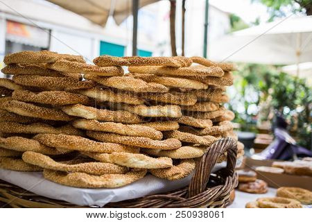 Traditional food concept.  Tray full of Greek traditional round sesame bread rings, displayed in a street market with bokeh background.
