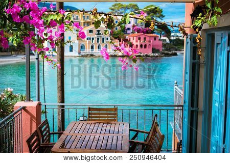 Lilac Fuchsia Blossom Flower Over Hotel Veranda In Front Of Turquoise Colored Bay Of Mediterranean S