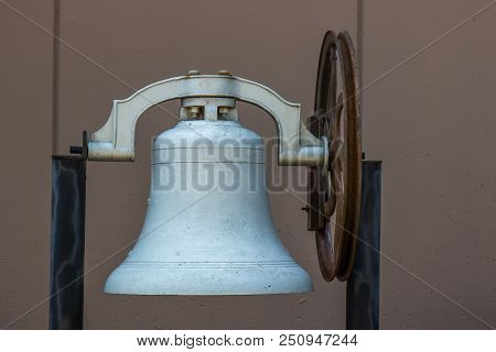 Old Iron Bell With Turning Wheel On Stand