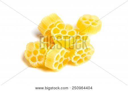 Raw Uncooked Rotelle Dry Italian Pasta. Ruote, Wagon Wheel Shaped. Heap, Isolated On White Backgroun