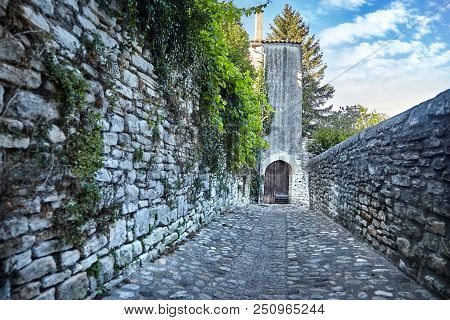 The Old Stone Pavement. The Road Leading To The House With Wooden Gates