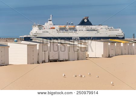 Calais, France - 19 June 2018: Beach Cabins And Dfds Cross Channel Ferry On Its Way To Dover, Uk.