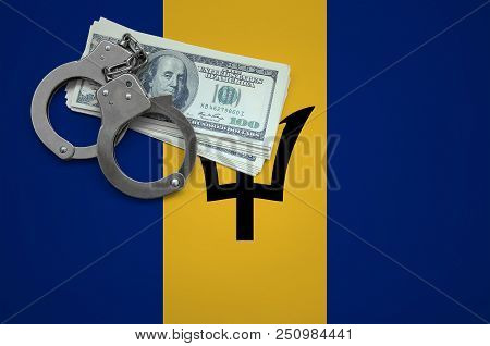Barbados Flag  With Handcuffs And A Bundle Of Dollars. The Concept Of Breaking The Law And Thieves C