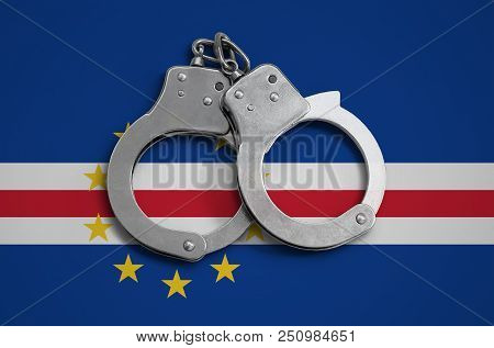 Cabo Verde Flag  And Police Handcuffs. The Concept Of Observance Of The Law In The Country And Prote