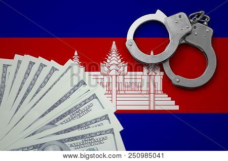 Cambodia Flag  With Handcuffs And A Bundle Of Dollars. The Concept Of Illegal Banking Operations In 
