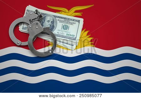 Kiribati Flag  With Handcuffs And A Bundle Of Dollars. The Concept Of Breaking The Law And Thieves C