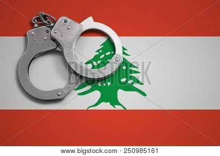 Lebanon Flag  And Police Handcuffs. The Concept Of Crime And Offenses In The Country.