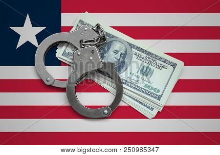 Liberia Flag  With Handcuffs And A Bundle Of Dollars. Currency Corruption In The Country. Financial 