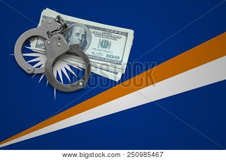 Marshall Islands Flag  With Handcuffs And A Bundle Of Dollars. The Concept Of Breaking The Law And T