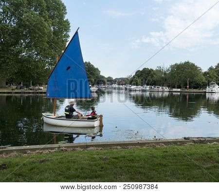 Beccles, Suffolk, Uk, July 2018 - Man And Boy In A Sailing Boat On The River Waveney, Beccles, Suffo