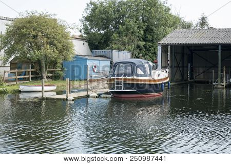 A Boat Morred Up In A Boatyard On The River Waveney, Beccles, Suffolk, Uk