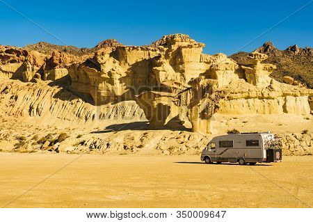 Bolnuevo, Spain - March 15, 2019: Camper Car On Parking Area At Eroded Yellow Sandstone Formations, 