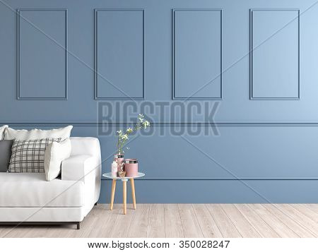 Interior Space Of A Pale Blue Wall With Mouldings Showing Part Of A White Couch And A Small Circular