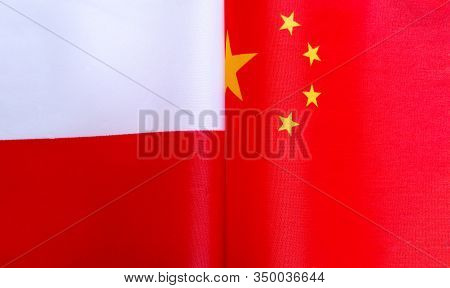 Fragments Of National Flags Of The Republic Of Poland And China In Close-up