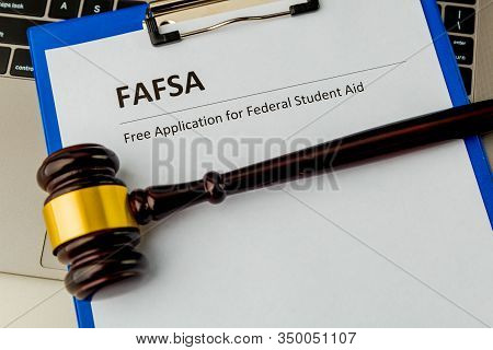 Document With Student Aid And Wooden Gavel On The Table With Laptop Isolated. Fafsa