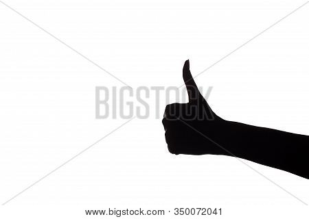 Hand Showing The Ok Gesture, Everything Is Good Or Like It. The Hand Holds The Thumb Up. Dark Hands 