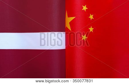 Fragments Of National Flags Of The Republic Of Latvia And China In Close-up