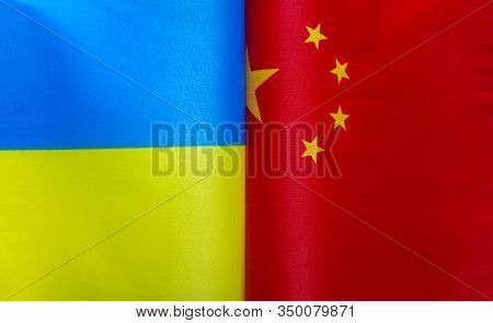 Fragments Of National Flags Of Ukraine And China Close-up