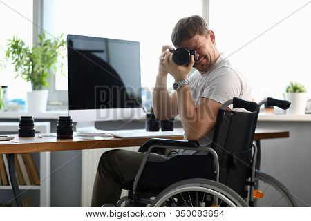 Male Disabled Photographer Holds Camera In His Hands And Takes Picture Portrait. Striving For A Goal