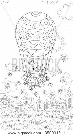 Little Easter Chick Flying In Its Holiday Basket With A Decorated Balloon Above A Small Toy Town On 