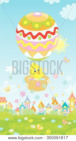 Little Easter Chick Flying In Its Holiday Basket With A Colorfully Decorated Balloon Above A Small T