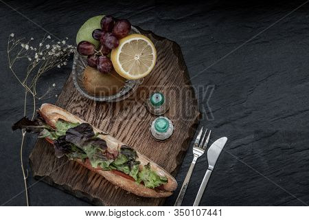 A Delicious Smoked Salmon Sesame Bread Sandwich With Fresh Fruit On A Wooden Plate. It Is Perfect Ea
