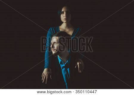 Art Portrait Of A Guy Who Holds In A Rue A Glass Of Wine, With The Girl Next To Him, On A Dark Backg