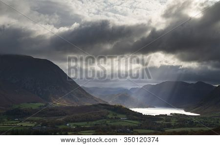 Epic Sun Beams Light Up Crummock Water In Dramatic Autumn Fall Landscape Image With Mellbreak And Gr