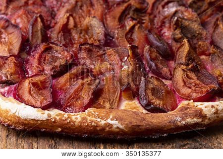 Closeup Of Bavarian Plum Pie On Dark Wood
