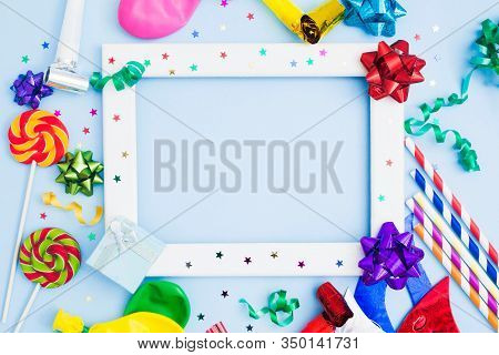 Brithday Background With White Wooden Frame And Colorful Festive Accessories. Copy Space. Flat Lay. 