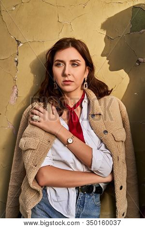 Beautiful Young Redhead Woman Wearing Teddy Jacket And White Shirt And Red Neckpiece Is Thinking Of 
