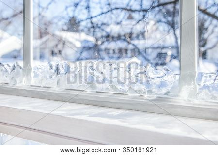 Ice forming on the inside of a window in the wintertime, shallow focus on ice