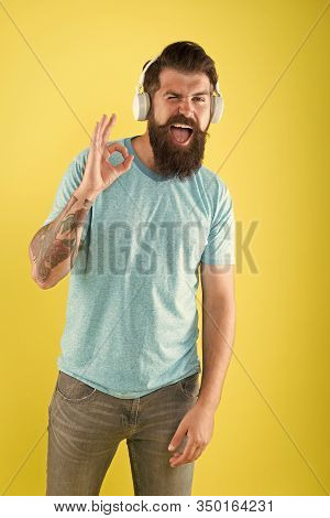 Hipster Happy Using Modern Wireless Headphones. Bearded Man Listening Music Wireless Gadget. Wireles