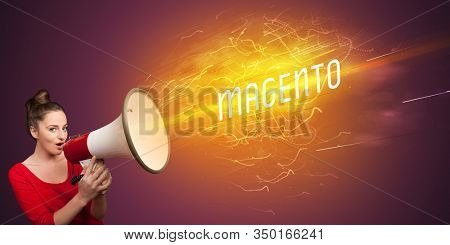 Young girld shouting in megaphone with MAGENTO inscription, online shopping concept