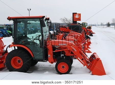 Chesley, Ontario / Canada - February 9, 2020: Row Of Kubota Farm Equipment On Lot In Snow