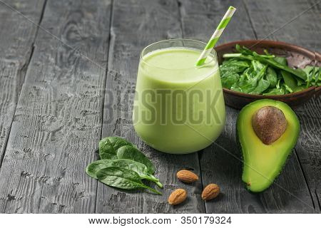Fresh Drink, Spinach Leaves And Half An Avocado On A Rustic Table. Fitness Product. Dietary Sports N