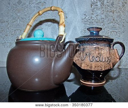 Black Clay Teapot With Bamboo Handle And A Vase For Honey With The Inscription 