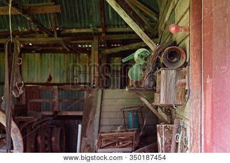Old Rusted Farm Tools From Yesteryear In An Abandoned Country Shed