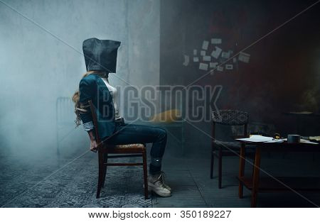 Victim of maniac kidnapper with a bag on her head