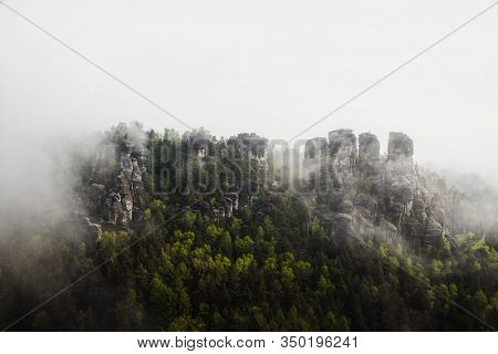 Panoramic View Of The Elbe Sandstone Mountains Covered In Fog In Saxony, Germany