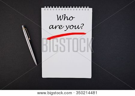 Notebook With The Inscription Who Are You On A Black Table.