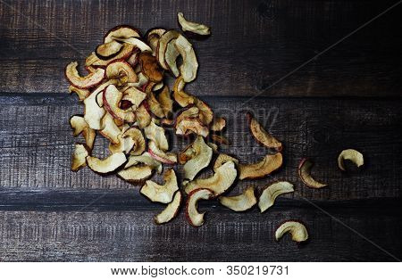 Dried Apple Chips On A Brown Wooden Table. Organic Natural Food. Top View. Flat Lay.