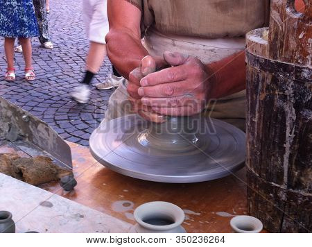 A Potter Artisan At Work During A Representation Of Medieval Life In An Italian Fair