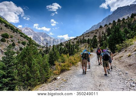 Turkey, Chamard - August 3, 2019: Tourists Walk Along The Road Through The Mountain Landscape In The