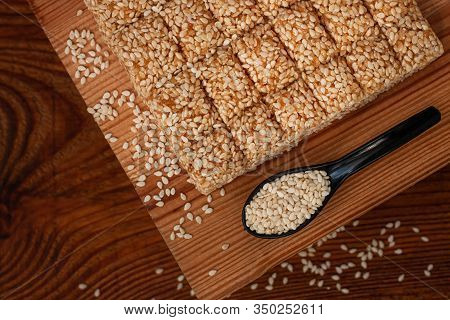 Honey Bars With Sesame Seeds Close-up On Wooden Background. Gozinaki Sweets. Traditional Oriental Co