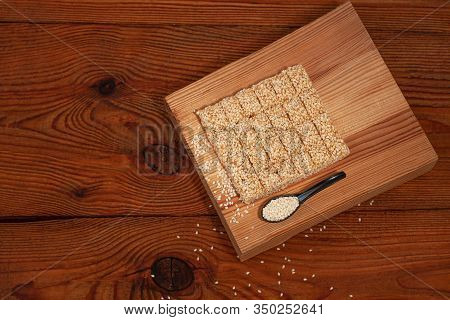 Honey Bars With Sesame Seeds Close-up On Wooden Background. Gozinaki Sweets. Traditional Oriental Co