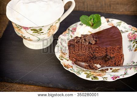 Creamy Chocolate Cake With Apricot Jam And Coffee On Table