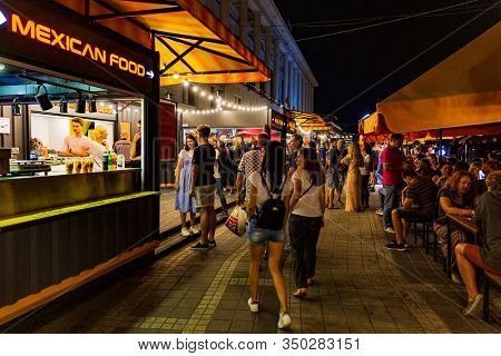 Kiev , Ukraine - August 31, 2019 : people at restaurants of Poshtova square on Dniepr river port waterfront Landmark of Kiev Ukraine Europe