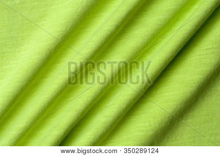 Close-up Fragment Of A Beautiful Yellow Cotton Fabric. Concept Of High-quality Raw Materials For Tai